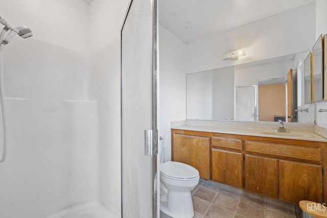 full bathroom with a stall shower, toilet, and vanity