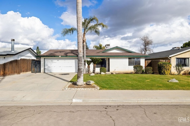 ranch-style home with driveway, an attached garage, fence, and a front yard