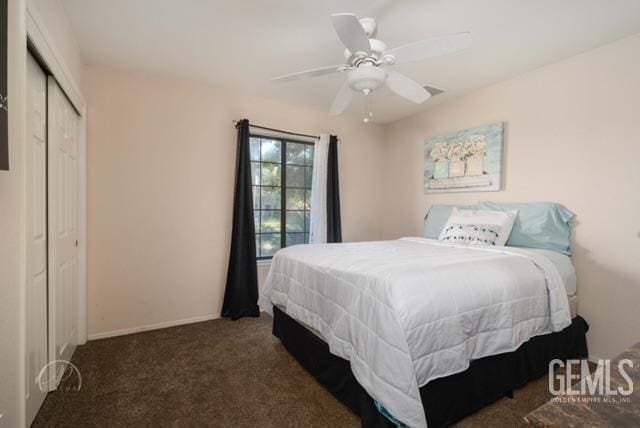 carpeted bedroom featuring ceiling fan and a closet