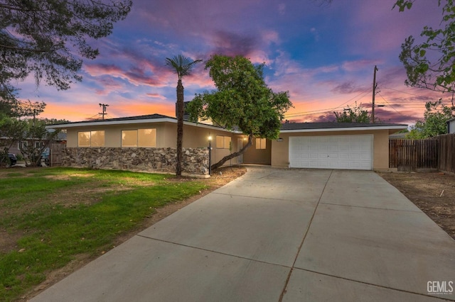 2414 Noble Ave, Bakersfield, CA 93306 - mid-century home featuring fence, a yard, concrete driveway, stucco siding, and a garage