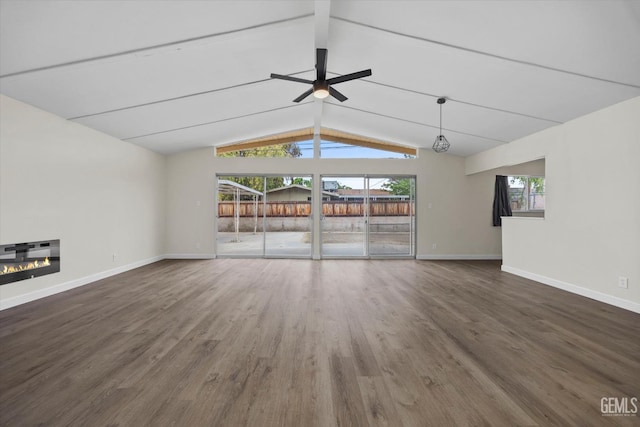 2414 Noble Ave, Bakersfield, CA 93306 - unfurnished living room with wood finished floors, a ceiling fan, vaulted ceiling with beams, baseboards, and a glass covered fireplace