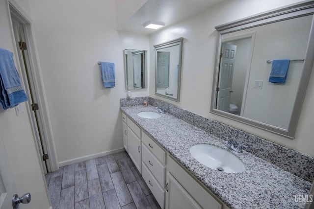 1805 Glenbrea Ct, Bakersfield, CA 93309 - full bath with wood tiled floor, a sink, double vanity, and toilet