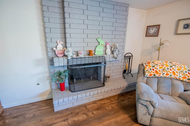1805 Glenbrea Ct, Bakersfield, CA 93309 - living room with baseboards, a brick fireplace, wood finished floors, and a textured ceiling