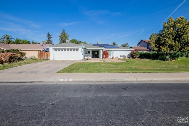 1805 Glenbrea Ct, Bakersfield, CA 93309 - single story home featuring concrete driveway, a front lawn, roof mounted solar panels, fence, and an attached garage