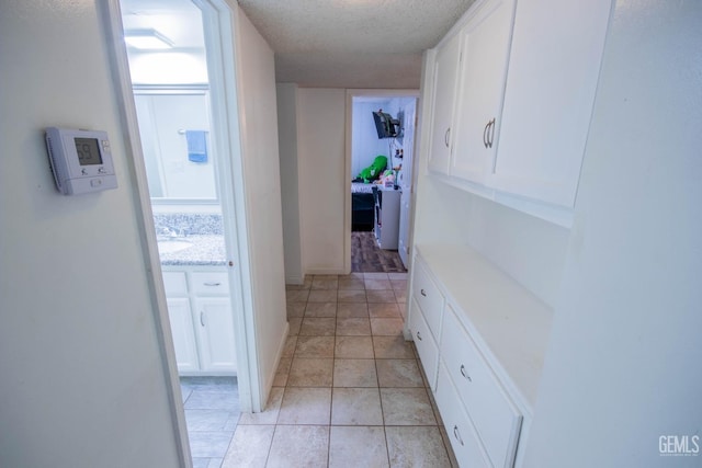 1805 Glenbrea Ct, Bakersfield, CA 93309 - corridor with a textured ceiling and light tile patterned floors