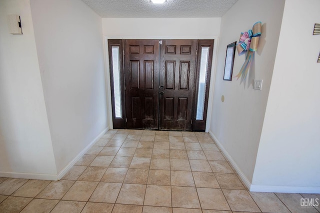 1805 Glenbrea Ct, Bakersfield, CA 93309 - entryway with light tile patterned floors, baseboards, a textured ceiling, and plenty of natural light