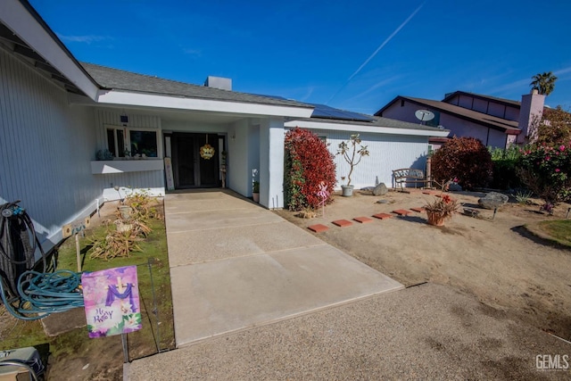 1805 Glenbrea Ct, Bakersfield, CA 93309 - entrance to property with roof mounted solar panels and a chimney