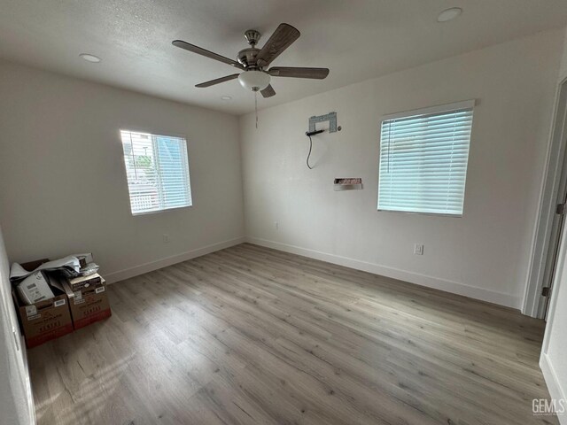 unfurnished room featuring light hardwood / wood-style floors and ceiling fan