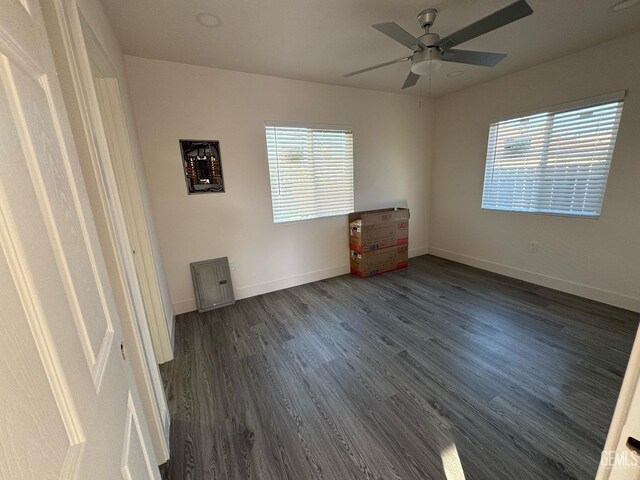 empty room featuring dark hardwood / wood-style floors, plenty of natural light, and ceiling fan