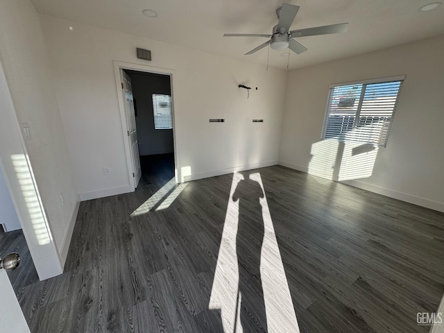 unfurnished room with dark hardwood / wood-style floors and ceiling fan