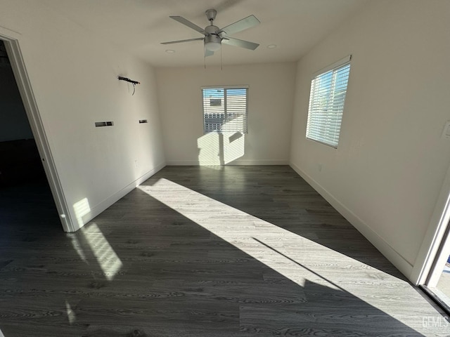 spare room featuring ceiling fan and dark wood-type flooring