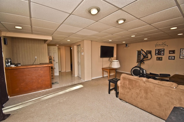 living room featuring a drop ceiling, recessed lighting, baseboards, and carpet floors