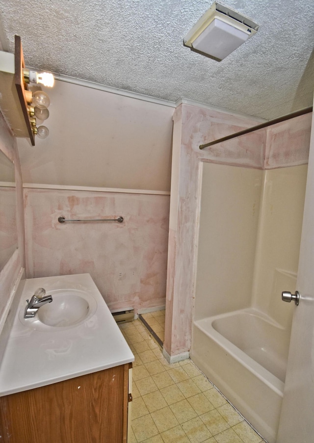 full bath with shower / tub combination, wainscoting, a textured ceiling, and vanity