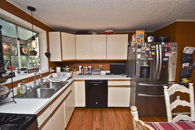 kitchen featuring a sink, dishwasher, light countertops, and stainless steel fridge with ice dispenser