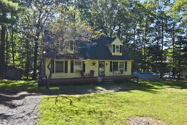 cape cod home with a front lawn and an outdoor pool