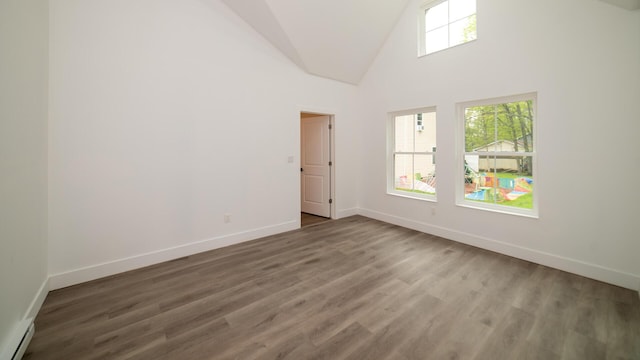 119 N Shore Dr, Albrightsville, PA 18210 - spare room featuring baseboard heating, baseboards, wood finished floors, and high vaulted ceiling