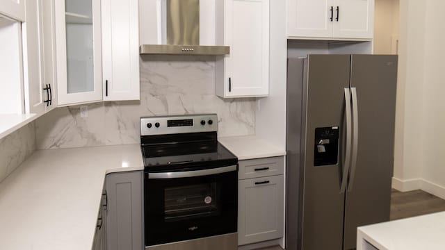 119 N Shore Dr, Albrightsville, PA 18210 - kitchen with stainless steel appliances, wall chimney exhaust hood, tasteful backsplash, and light countertops