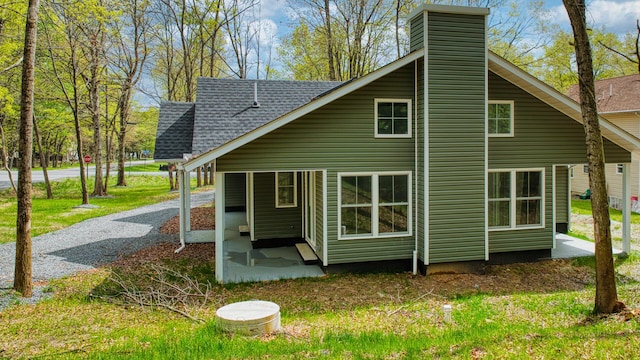 119 N Shore Dr, Albrightsville, PA 18210 - back of property featuring a chimney, roof with shingles, and a patio area