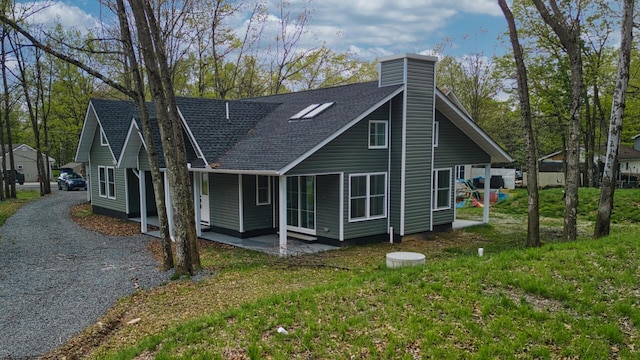 119 N Shore Dr, Albrightsville, PA 18210 - view of side of property with a shingled roof, a chimney, and a lawn