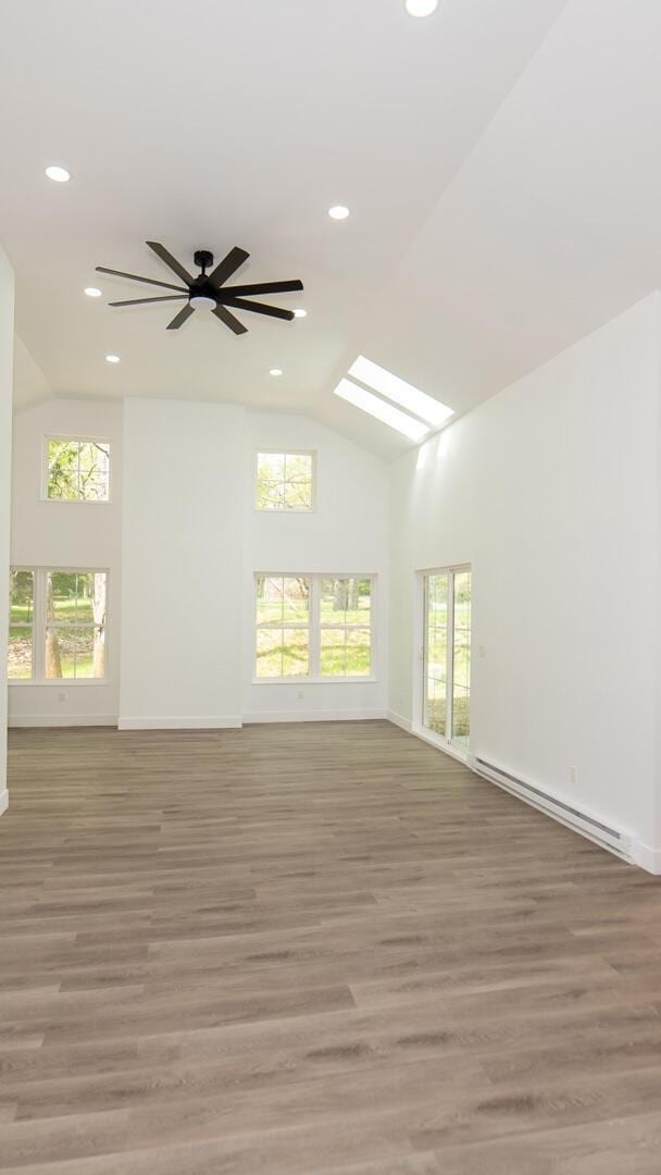 119 N Shore Dr, Albrightsville, PA 18210 - unfurnished room featuring a baseboard heating unit, light wood finished floors, recessed lighting, high vaulted ceiling, and baseboards