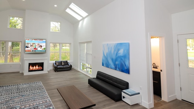 119 N Shore Dr, Albrightsville, PA 18210 - living room featuring high vaulted ceiling, a lit fireplace, healthy amount of natural light, wood finished floors, and recessed lighting