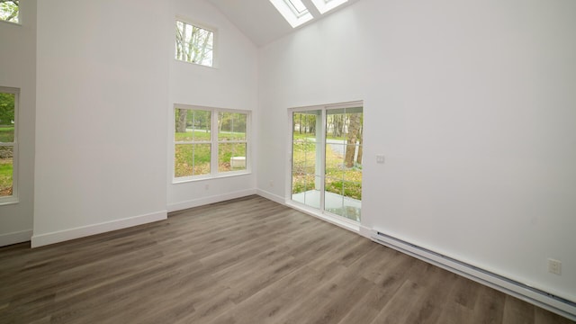 119 N Shore Dr, Albrightsville, PA 18210 - unfurnished room featuring a baseboard heating unit, a skylight, high vaulted ceiling, plenty of natural light, and wood finished floors