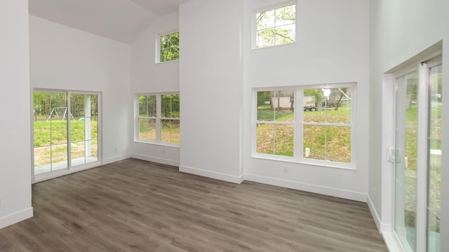 119 N Shore Dr, Albrightsville, PA 18210 - unfurnished living room featuring high vaulted ceiling, baseboards, healthy amount of natural light, and wood finished floors