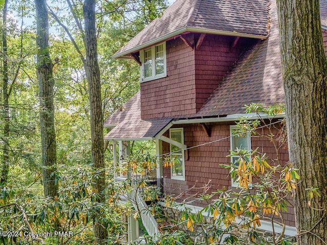 view of home's exterior with a shingled roof