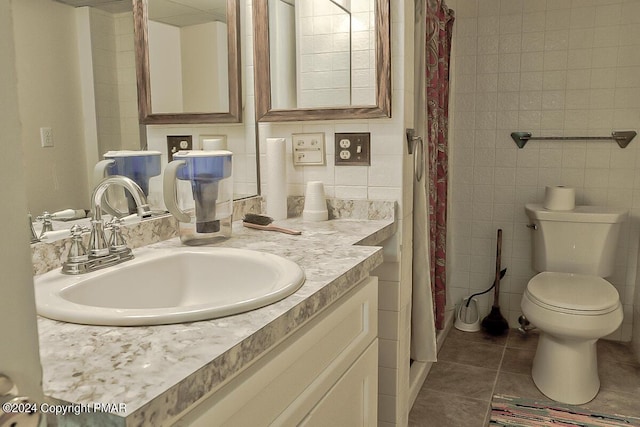 full bathroom featuring vanity, tile walls, toilet, and tile patterned floors