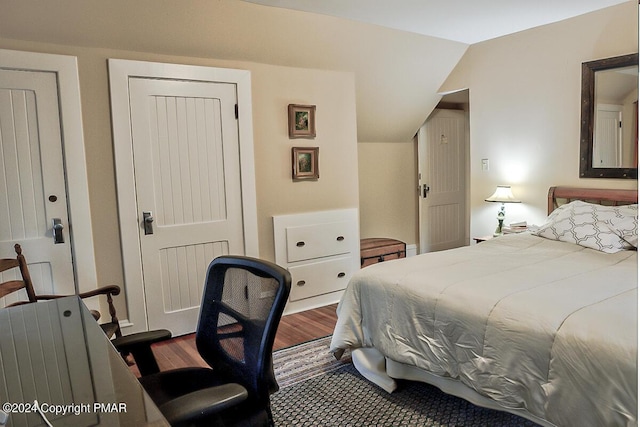 bedroom featuring vaulted ceiling and dark wood finished floors