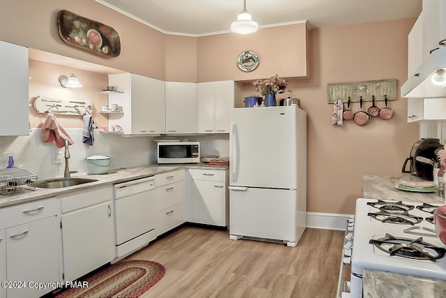 kitchen featuring white appliances, white cabinets, light countertops, backsplash, and light wood finished floors