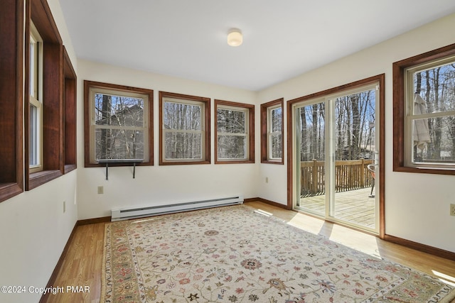 unfurnished sunroom with a baseboard radiator