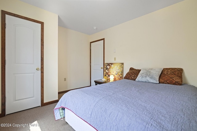 bedroom featuring baseboards and carpet flooring