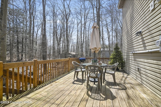 wooden deck featuring outdoor dining area