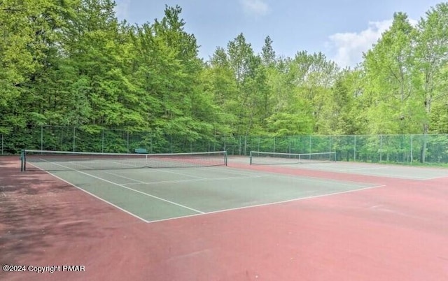 view of tennis court with fence