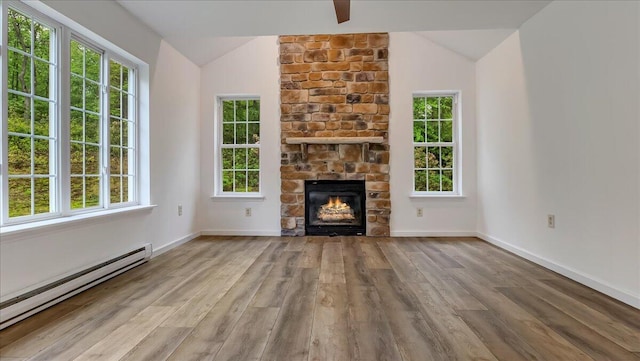 79 Delaware Dr, Jim Thorpe, PA 18229 - unfurnished living room featuring a baseboard heating unit, lofted ceiling, wood finished floors, a fireplace, and baseboards