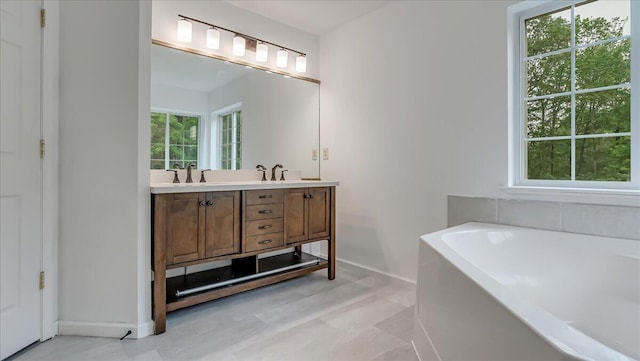 79 Delaware Dr, Jim Thorpe, PA 18229 - bathroom featuring baseboards, double vanity, and a garden tub