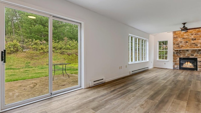 79 Delaware Dr, Jim Thorpe, PA 18229 - unfurnished living room featuring a baseboard radiator, plenty of natural light, and wood finished floors