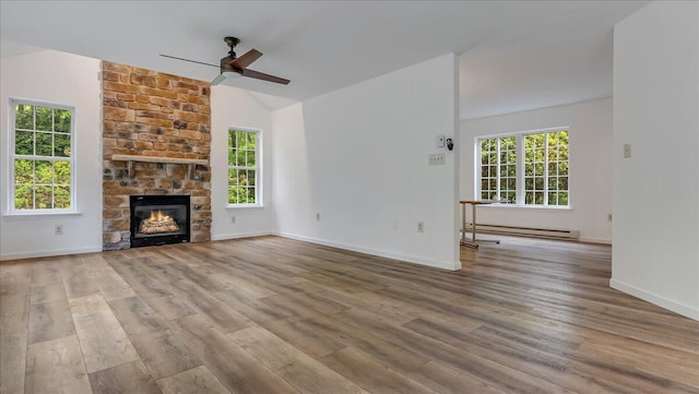 79 Delaware Dr, Jim Thorpe, PA 18229 - unfurnished living room featuring a baseboard heating unit, a ceiling fan, wood finished floors, baseboards, and lofted ceiling