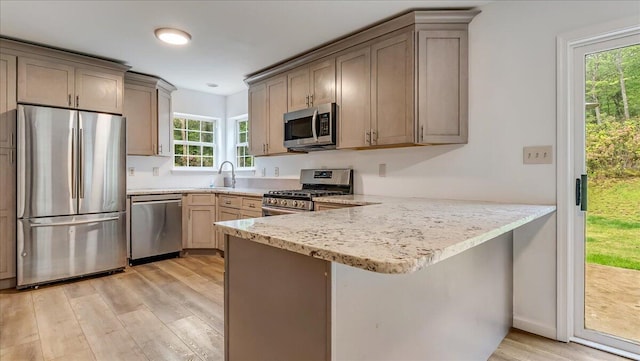 79 Delaware Dr, Jim Thorpe, PA 18229 - kitchen featuring stainless steel appliances, a peninsula, light wood-style floors, a sink, and light stone countertops