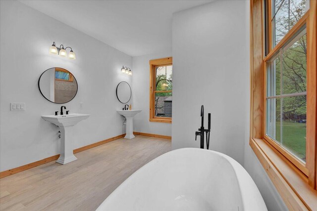 1448 Lake Ln, Pocono Lake, PA 18347 - full bathroom featuring wood finished floors, a soaking tub, and baseboards