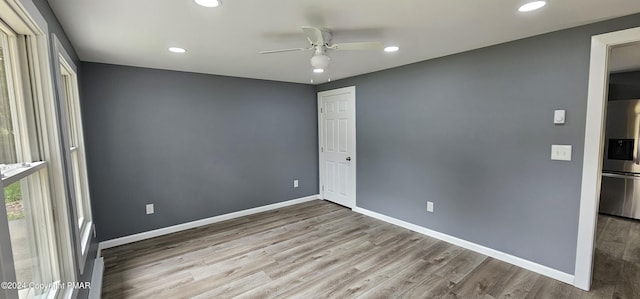 unfurnished room featuring recessed lighting, baseboards, wood finished floors, and a ceiling fan