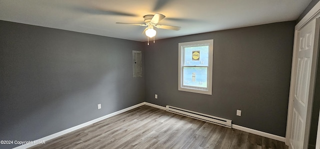 empty room with baseboards, a baseboard heating unit, ceiling fan, and wood finished floors