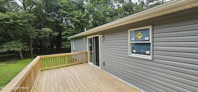 wooden terrace featuring a yard