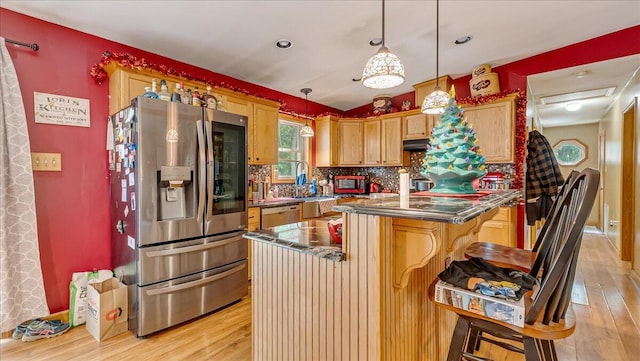 600 N Harrity Rd, Palmerton, PA 18071 - kitchen with stainless steel appliances, light wood-style flooring, backsplash, a kitchen bar, and pendant lighting