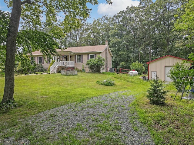 600 N Harrity Rd, Palmerton, PA 18071 - ranch-style home featuring a chimney, an outbuilding, a front yard, driveway, and a garage