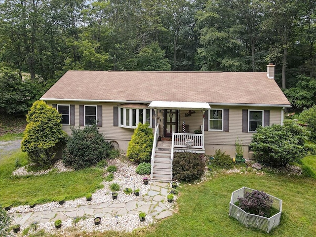 600 N Harrity Rd, Palmerton, PA 18071 - ranch-style house featuring covered porch, a front yard, a chimney, a vegetable garden, and stairs