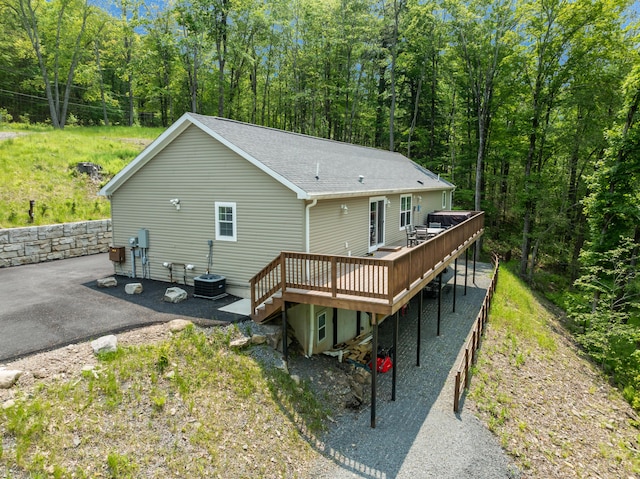 2016 Locust Ridge Rd, Pocono Lake, PA 18347 - back of property with a deck, a shingled roof, and a wooded view