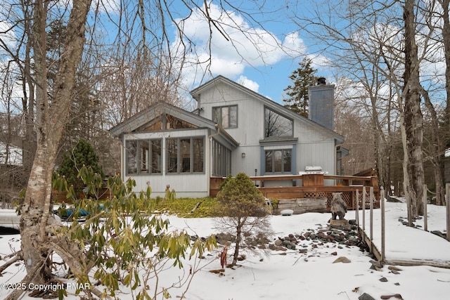 2222 Hillcrest Dr, Pocono Pines, PA 18350 - exterior space featuring a chimney, a deck, and a sunroom