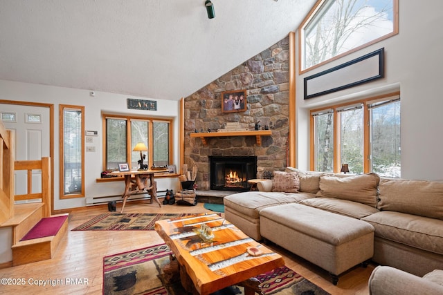 2222 Hillcrest Dr, Pocono Pines, PA 18350 - living room featuring a baseboard radiator, a fireplace, a textured ceiling, high vaulted ceiling, and wood-type flooring